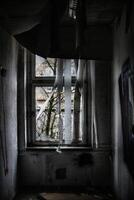 Dark shot of desolate room with debris and wallpaper falling off photo