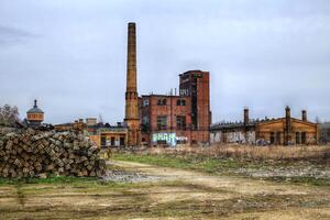 Power house of a huge former railway workshop in Germany, with big smokestack photo