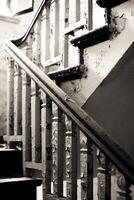 Black and white image of destroyed staircase railing photo