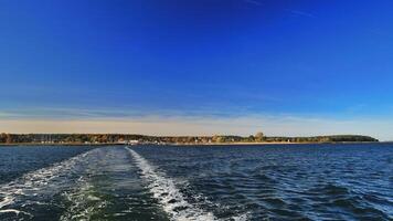 Backwash of a small coastal boat in the Baltic Sea photo