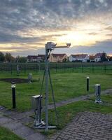 Weather station in Germany with a modern laser disdrometer measuring precipitation photo