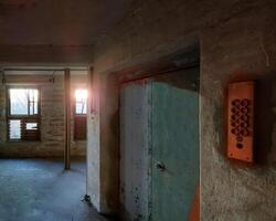 Desolate elevator door in an abandoned warehouse photo