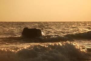 Waves splashing against rock at the coast photo