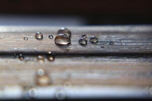 Close up of water drops on impregnated wooden surface photo