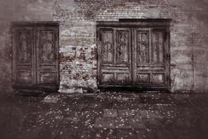 Weathered doors in grungy shot of a ruined facade photo
