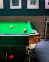 Taaditional snooker balls and game table from side view photo
