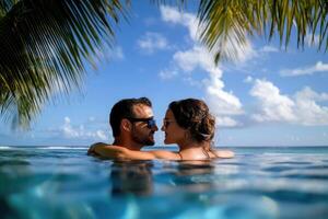 Couple enjoying beach vacation holidays at tropical resort with swimming pool and coconut palm trees near the coast with beautiful landscape. photo