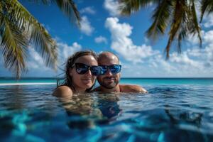 Couple enjoying beach vacation holidays at tropical resort with swimming pool and coconut palm trees near the coast with beautiful landscape. photo
