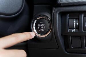 Close up of someone trying to ignition car by push start button. photo