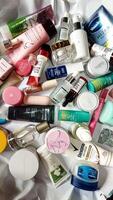 Surakarta, Indonesia - Desember 15, 2024. Many used bottles and jars for different brandy feminines. Containers for shampoo and lotions, cans for creams and face masks photo
