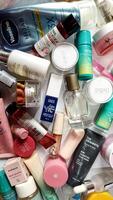 Surakarta, Indonesia - Desember 15, 2024. Many used bottles and jars for different brandy feminines. Containers for shampoo and lotions, cans for creams and face masks photo