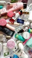 Surakarta, Indonesia - Desember 15, 2024. Many used bottles and jars for different brandy feminines. Containers for shampoo and lotions, cans for creams and face masks photo