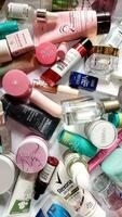 Surakarta, Indonesia - Desember 15, 2024. Many used bottles and jars for different brandy feminines. Containers for shampoo and lotions, cans for creams and face masks photo