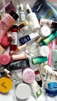 Surakarta, Indonesia - Desember 15, 2024. Many used bottles and jars for different brandy feminines. Containers for shampoo and lotions, cans for creams and face masks photo