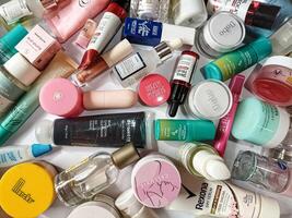 Surakarta, Indonesia - Desember 15, 2024. Many used bottles and jars for different brandy feminines. Containers for shampoo and lotions, cans for creams and face masks photo