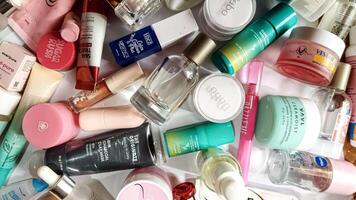 Surakarta, Indonesia - Desember 15, 2024. Many used bottles and jars for different brandy feminines. Containers for shampoo and lotions, cans for creams and face masks photo