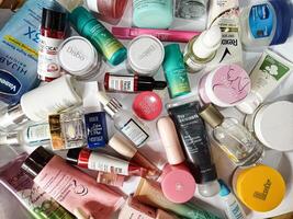 Surakarta, Indonesia - Desember 15, 2024. Many used bottles and jars for different brandy feminines. Containers for shampoo and lotions, cans for creams and face masks photo