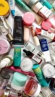 Surakarta, Indonesia - Desember 15, 2024. Many used bottles and jars for different brandy feminines. Containers for shampoo and lotions, cans for creams and face masks photo