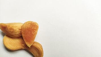 Garlic that turns into golden garlic has a slightly transparent golden yellow color, with a soft texture that tends to be sticky. Golden garlic isolated on white background. photo