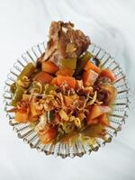 Asem-asem Daging or Vegetable Sour Beef Soup is typical dish of Java, Indonesia. With beef, carrot and beans as ingredients plus Javanesse starfruit. photo
