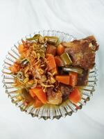 Asem-asem Daging or Vegetable Sour Beef Soup is typical dish of Java, Indonesia. With beef, carrot and beans as ingredients plus Javanesse starfruit. photo
