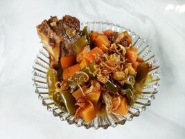 Asem-asem Daging or Vegetable Sour Beef Soup is typical dish of Java, Indonesia. With beef, carrot and beans as ingredients plus Javanesse starfruit. photo