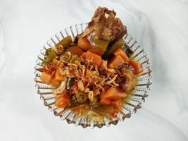 Asem-asem Daging or Vegetable Sour Beef Soup is typical dish of Java, Indonesia. With beef, carrot and beans as ingredients plus Javanesse starfruit. photo