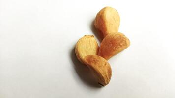Garlic that turns into golden garlic has a slightly transparent golden yellow color, with a soft texture that tends to be sticky. Golden garlic isolated on white background. photo