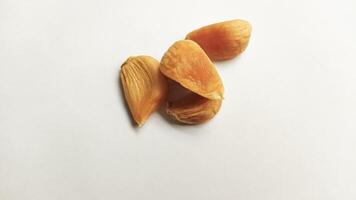 Garlic that turns into golden garlic has a slightly transparent golden yellow color, with a soft texture that tends to be sticky. Golden garlic isolated on white background. photo