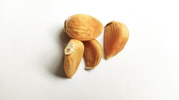 Garlic that turns into golden garlic has a slightly transparent golden yellow color, with a soft texture that tends to be sticky. Golden garlic isolated on white background. photo