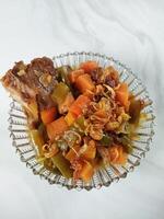 Asem-asem Daging or Vegetable Sour Beef Soup is typical dish of Java, Indonesia. With beef, carrot and beans as ingredients plus Javanesse starfruit. photo