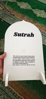 White board sutrah used for the barrier of people praying on the carpet of the mosque photo