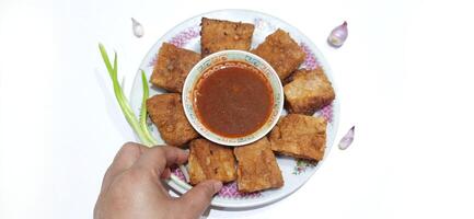 Martabak telur or Martabak telor. Savory pan fried pastry stuffed with egg, meat and spices served with sauce, Indonesian street food photo