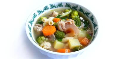 Sayur sop or vegetable with meat soup on the plate. Indonesian popular culinary. Healthy food and delicious photo