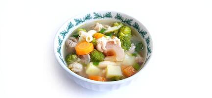 Sayur sop or vegetable with meat soup on the plate. Indonesian popular culinary. Healthy food and delicious photo