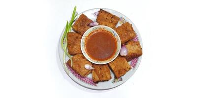Martabak telur or Martabak telor. Savory pan fried pastry stuffed with egg, meat and spices served with sauce, Indonesian street food photo
