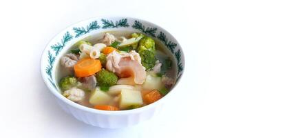 Sayur sop or vegetable with meat soup on the plate. Indonesian popular culinary. Healthy food and delicious photo