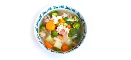 Sayur sop or vegetable with meat soup on the plate. Indonesian popular culinary. Healthy food and delicious photo