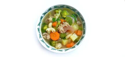 Sayur sop or vegetable with meat soup on the plate. Indonesian popular culinary. Healthy food and delicious photo