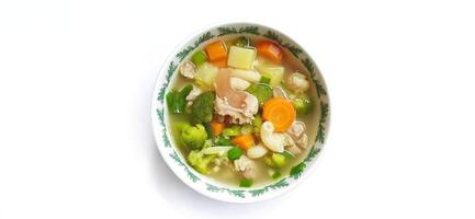 Sayur sop or vegetable with meat soup on the plate. Indonesian popular culinary. Healthy food and delicious photo