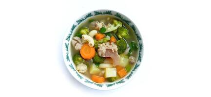 Sayur sop or vegetable with meat soup on the plate. Indonesian popular culinary. Healthy food and delicious photo