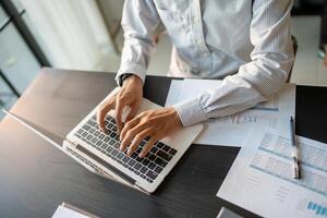 Business man working using laptop computer Hands typing keyboard. Professional investor working start up project. business planning in office. Technology business photo