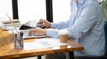 Business man working by using laptop computer Hands typing on a keyboard. Professional investor working new start up project. business planning in office. Technology business Concept. photo
