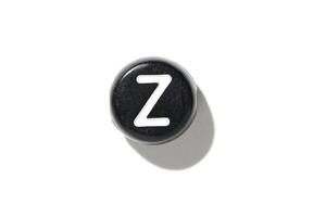 Black keyboard key with z letter on white background and shadow from overhead perspective photo