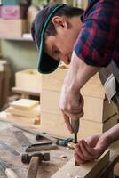 Carpenter working with a chisel photo