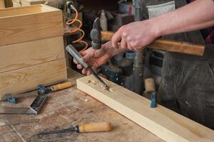 Carpenter working with a chisel photo