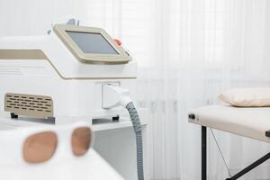 Room in spa center with laser epilation equipment photo