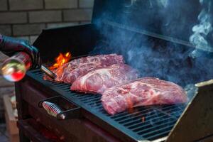 Pork meat steaks on the grill photo
