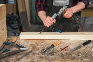 Carpenter working with a chisel photo
