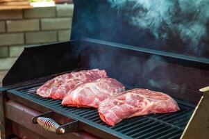Pork meat steaks on the grill photo
